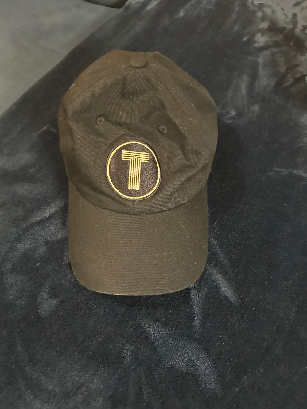 The Classic Black Baseball Cap with Gold 'T' Emblem